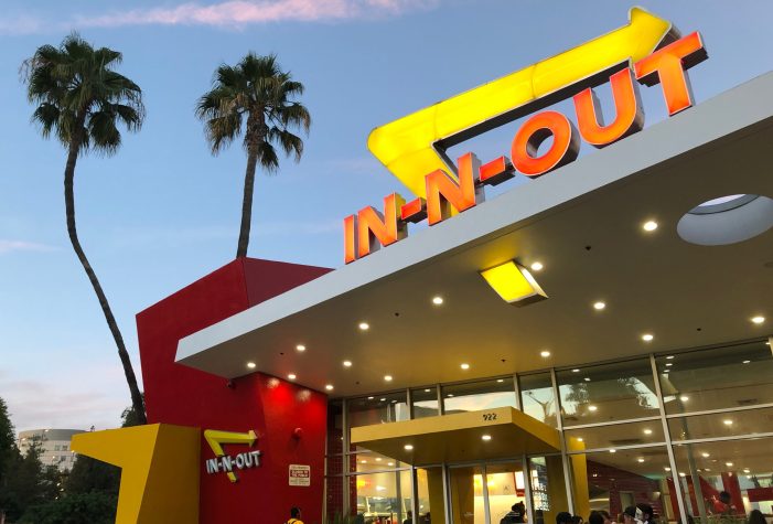 The outside of an In-N-Out restaurant at dusk.