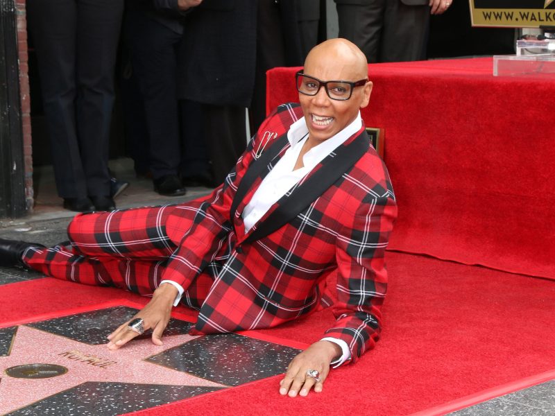 RuPaul in a red plaid suit at his Hollywood Walk of Fame star in 2018