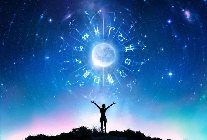 Person with outstretched arms looking at a starry sky with the zodiac signs around a moon.