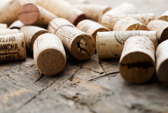 Close up of wine corks on a wood table.