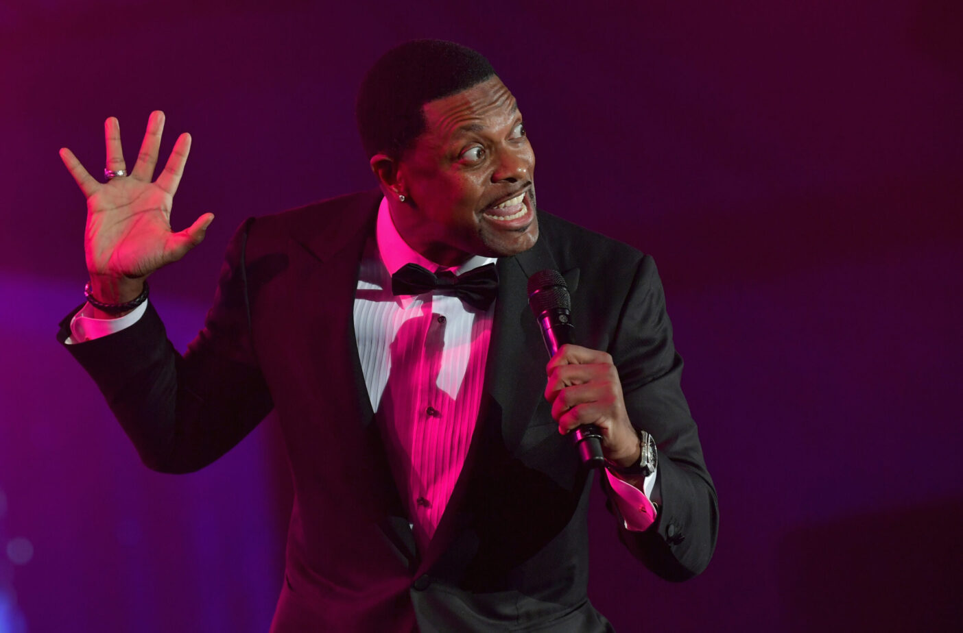 PHOENIX, AZ - MARCH 23: Chris Tucker speaks onstage during Celebrity Fight Night XXV on March 23, 2019 in Phoenix, Arizona.