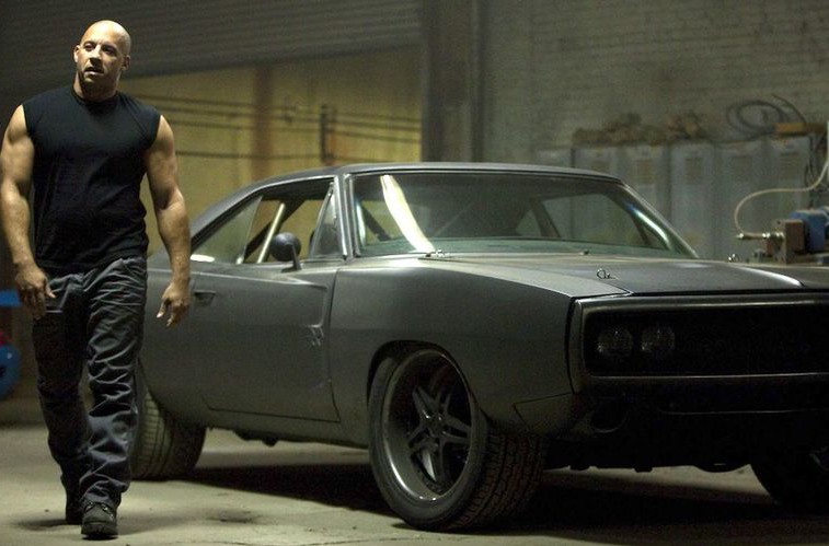 A screenshot from Fast Five featuring Vin Diesel walking away from the 1970 Dodge Charger
