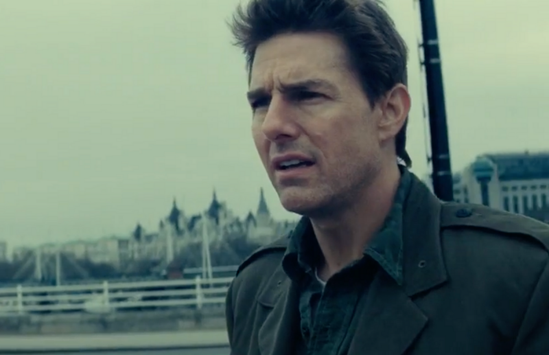 A still from the film Edge Of Tomorrow starring Tom Cruise, who stands atop a bridge in London weari