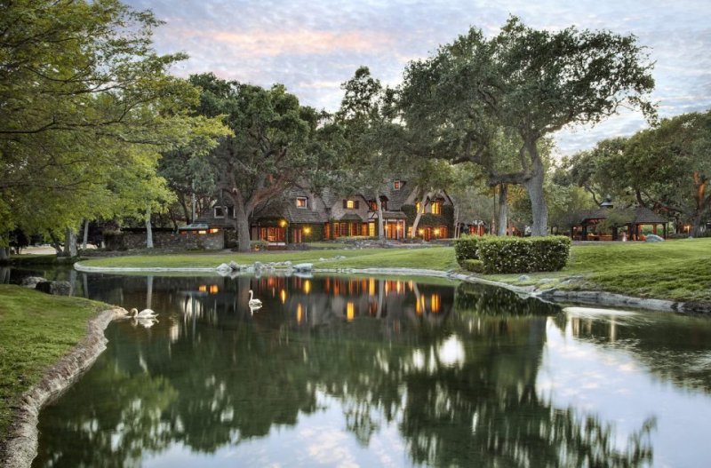 A view of Neverland Ranch with a water feature in the foreground