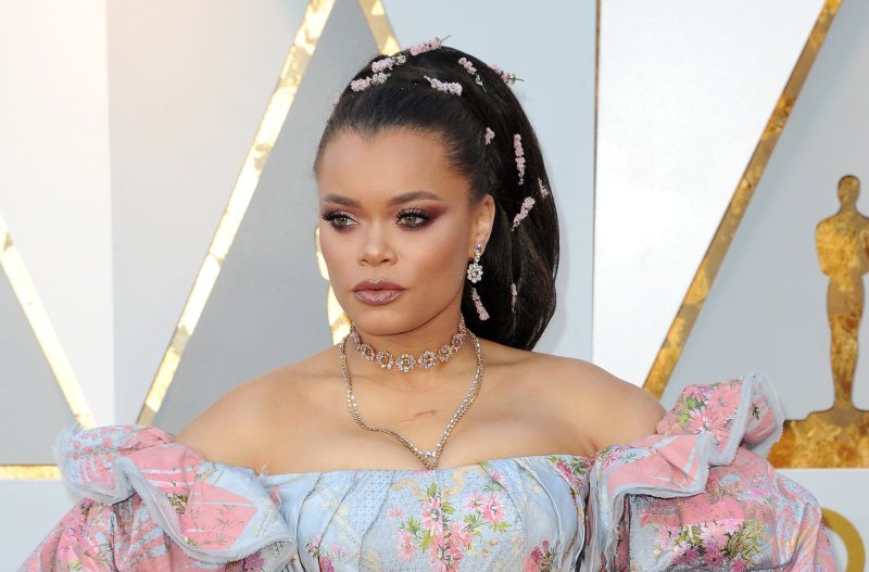Andra Day posing on the red carpet at the 2018 Oscars