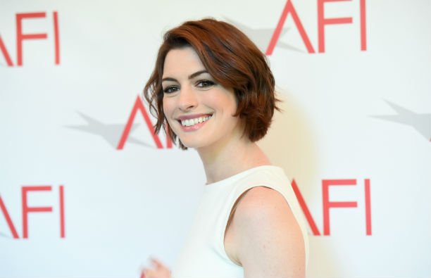 Anne Hathaway wearing a white ensemble on the red carpet