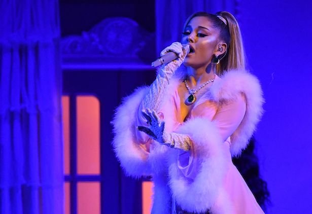 Ariana Grande in a pink and feathery outfit performing at the Grammys