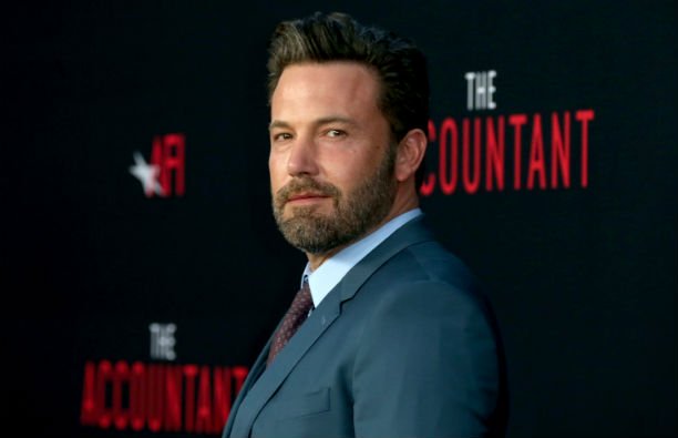 Ben Affleck in a gray suit on the red carpet.