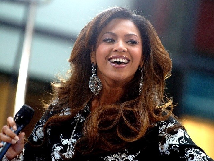 Beyonce performing onstage in a black, bedazzled jacket