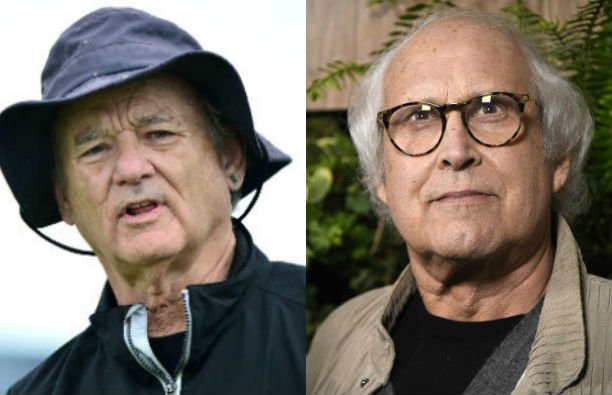 Bill Murray in a black jacket and rain hat on a golf course. Chevy Chase in a tan sweater and black