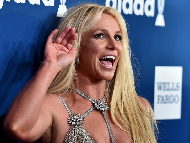 Britney Spears wearing a sparkly silver dress on the red carpet