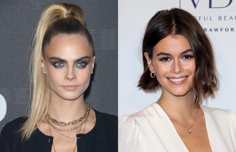 Cara Delevingne (left) wearing a black blouse. Kaia Gerber (right) wearing a white blouse