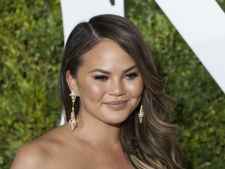 Chrissy Teigen wearing a strapless dress on the red carpet