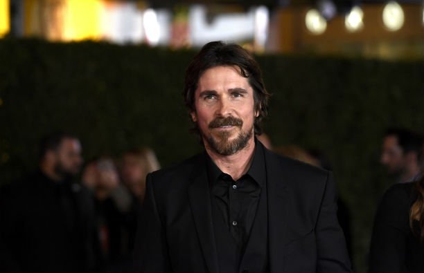 Christian Bale in a black suit on the red carpet