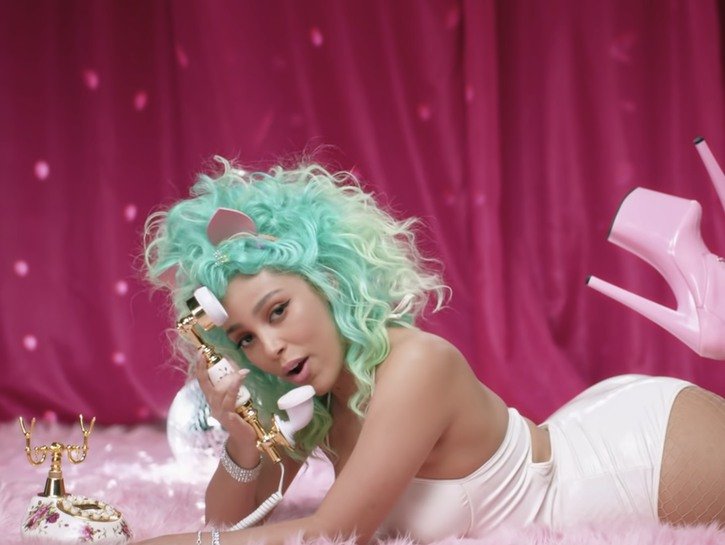 Doja Cat in a mint green wig during her music video for her song Go To Town