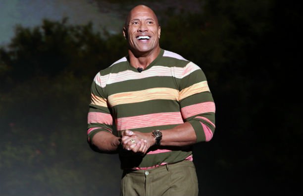 Dwayne "The Rock" Johnson in a sunset-ombre stripped shirt at the D23 Expo