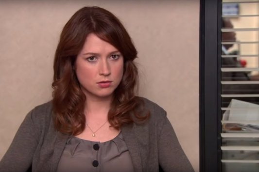 Ellie Kemper in a dark blouse and cardigan as Erin on NBC's The Office