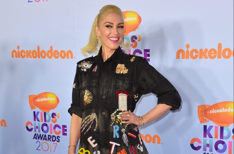 Gwen Stefani wearing a black denim dress with patches sewn on it at the Kids' Choice Awards