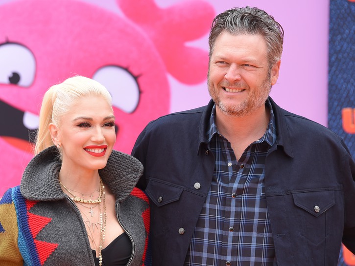 Gwen Stefani, wearing multicolored jacket, posing with Blake Shelton at the _Ugly Dolls_ premier
