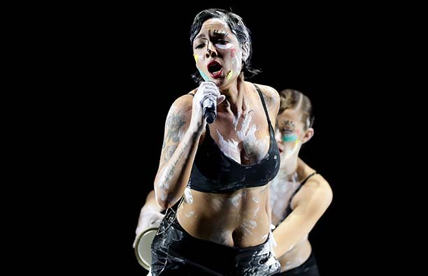 Halsey performing, covered in paint.