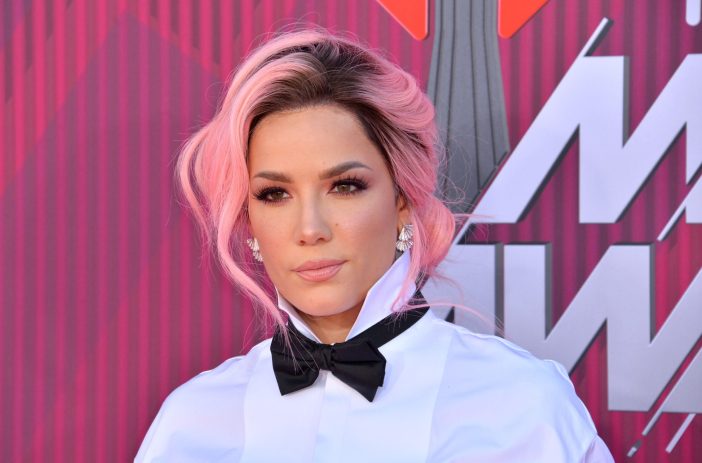 Halsey with pink hair, wearing a bow tie