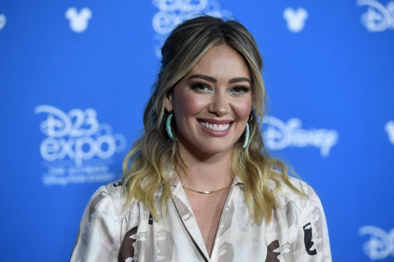 Hilary Duff in a beige shirt on the red carpet
