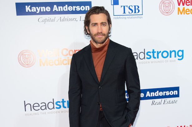 Jake Gyllenhaal in a black jacket and orange turtleneck