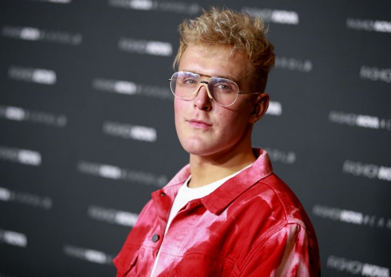 Jake Paul wearing a red jacket on the red carpet