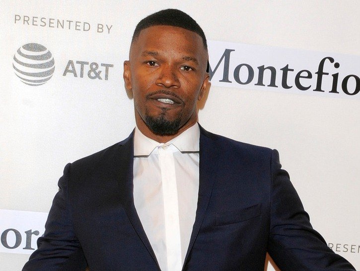 Jamie Foxx wearing a black suit and no tie to the Tribeca Film Festival