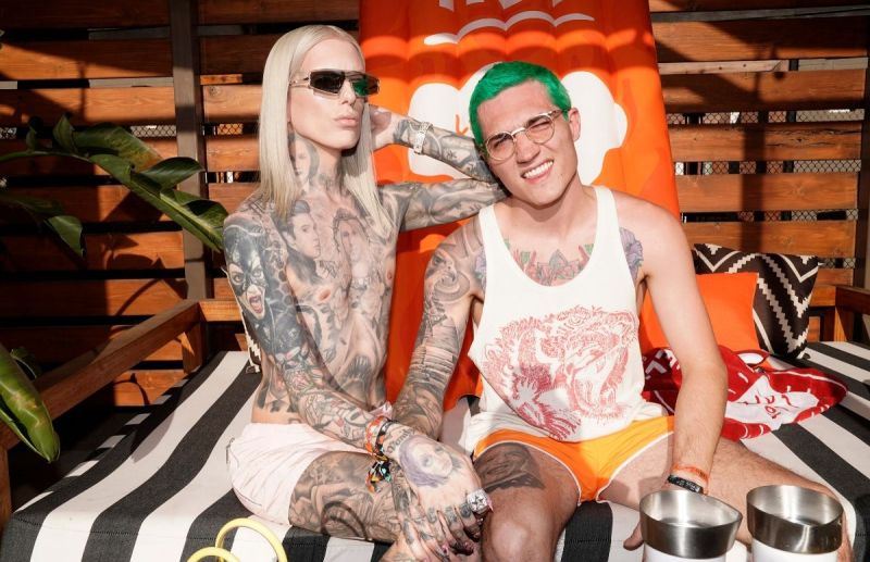 Jeffree Star wearing a pair of white short-short sitting with Nathan Scwhandt, who's wearing a white