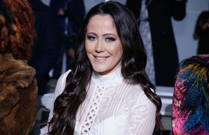 Jenelle Evans in a white blouse front row at a fashion show