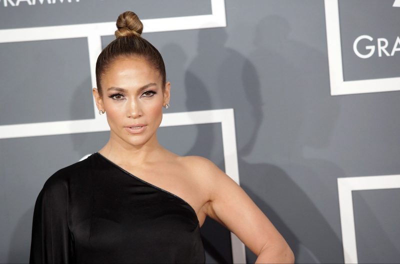 Jennifer Lopez wears an off the shoulder black dress at the Grammy Awards