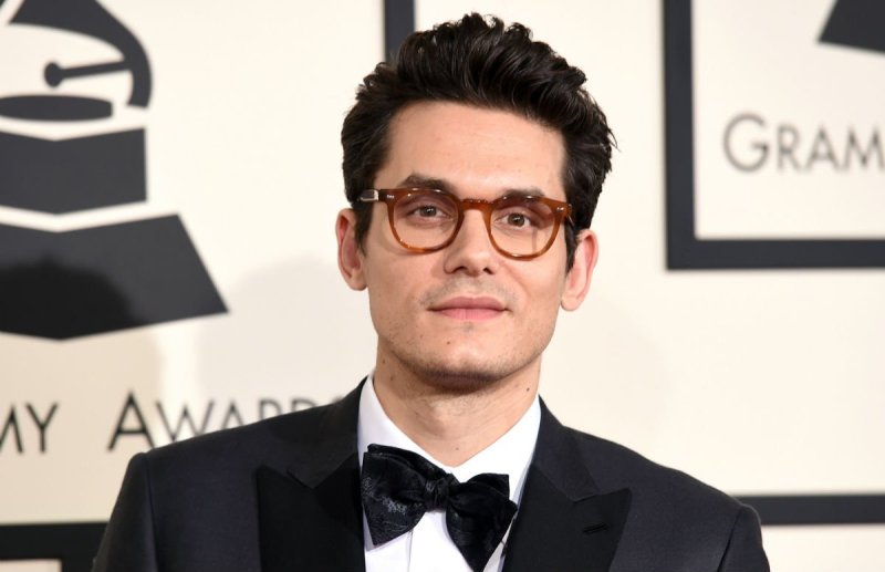 John Mayer wearing a black tux on the red carpet
