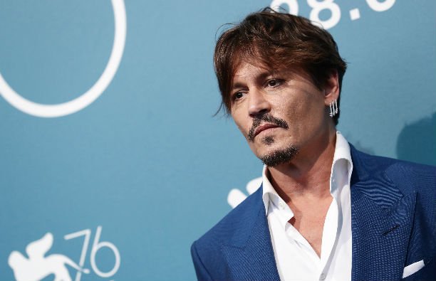 Johnny Depp in a blue suit on the red carpet