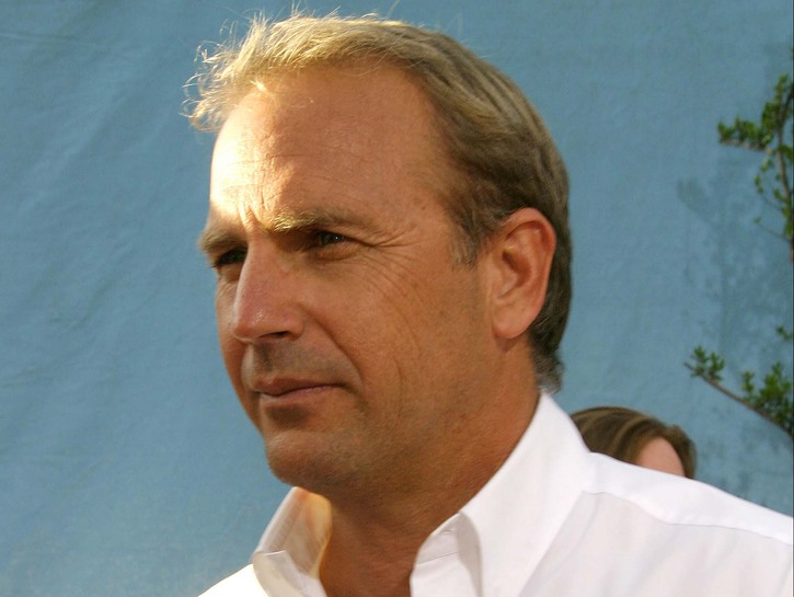 Kevin Costner wearing a casual white, button down shirt at the premiere of Open Range