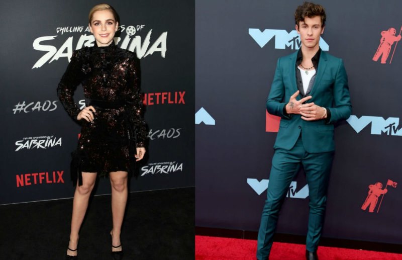 Kiernan Shipka in a black dress on the red carpet. Shawn Mendes in a teal suit on the red carpet.