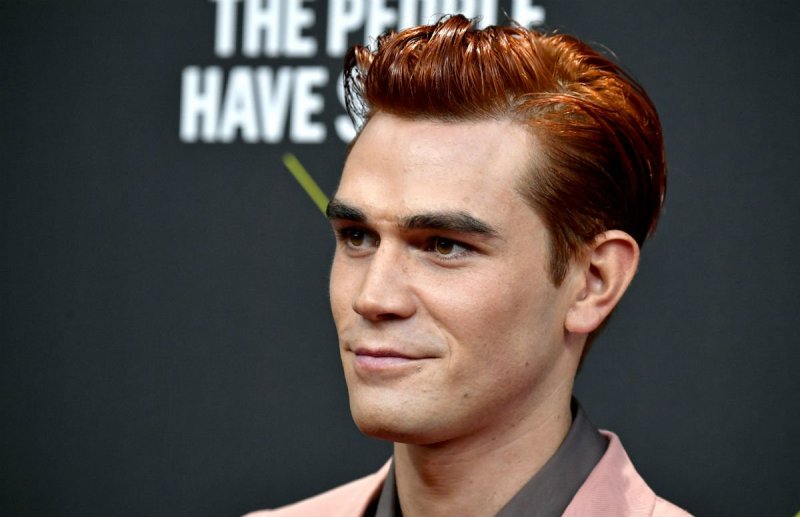 KJ Apa in a pink suit on the red carpet