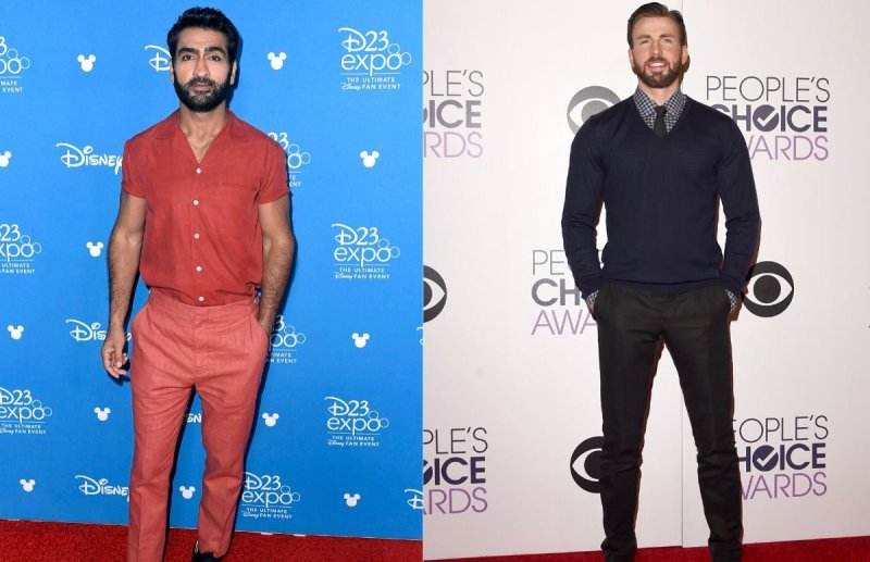Kumail Nanjiani wearing a reddish-orange shirt and salmon colored pants on the red carpet. Chris Eva