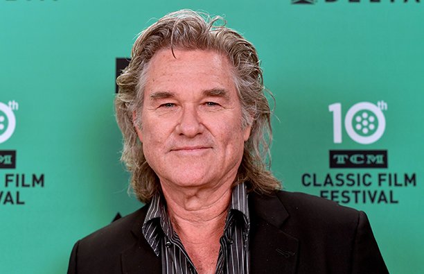 Kurt Russell in front of green background