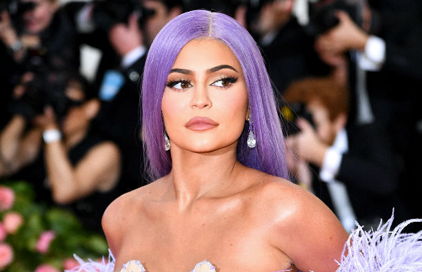 Kylie Jenner in a purple, feathered dress and purple wig at the Met Gala