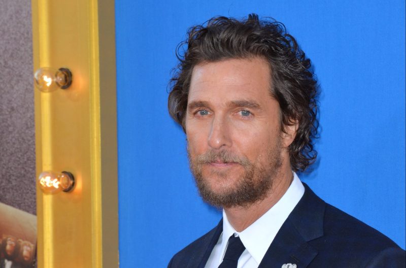Matthew McConaughey attends the premiere of Sing wearing a dark suit