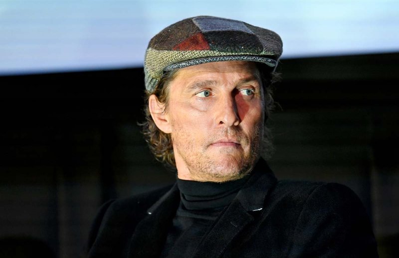 Matthew McConaughey looking to the left, wearing a hat