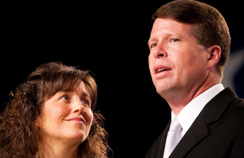 Michelle and Jim Bob Duggar on stage at a political event