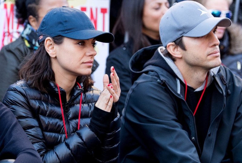 Mila Kunis and Ashton Kutcher attend the women's march Los Angeles