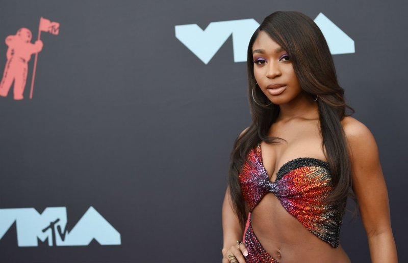 Normani wearing a multi-colored top on the red carpet