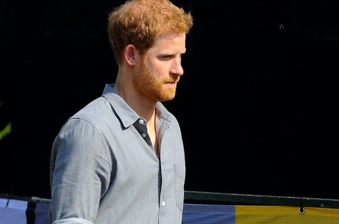 Prince Harry in a blue button down shirt