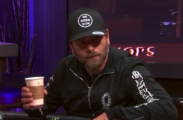 Rick Salomon paying poker with a coffee cup in his hand.