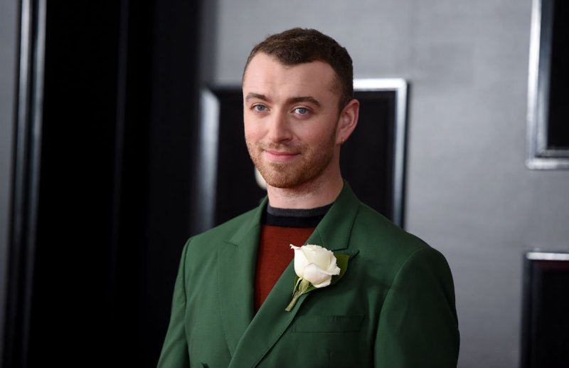 Sam Smith wearing a green suit on the red carpet