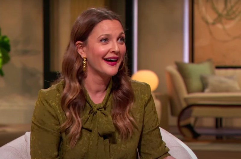 Screenshot of the Drew Barrymore Show with Drew Barrymore talking in a green outfit