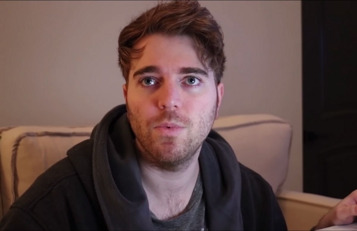 Shane Dawson wearing a brown robe in his home.